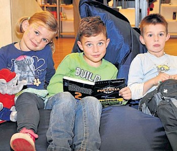 Auf dem Sitzsack: Romy und Aaron Wenzel (mit Buch) und Jannis Ruby (mit Lesekarten) nutzten eine der vielen gemütlichen Leseecken in der Melsunger Stadtbücherei. Fotos: Dürr
